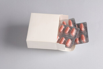 White box mockup with blisters pills on gray background. Template for design
