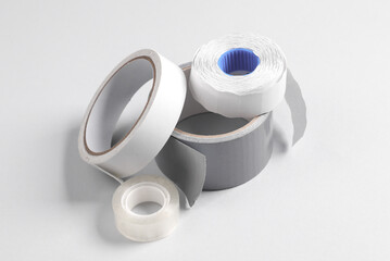 Different rolls of duct tapes on gray background