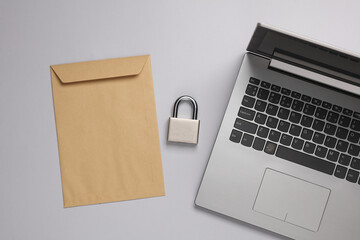 Top secret. Save information. Laptop, Envelope with lock on gray background