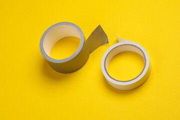 Rolls of duct tape on yellow background