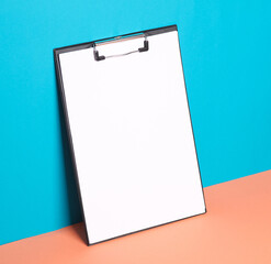 Blank clipboard on blue pink background. Creative layout, mockup