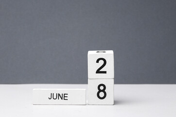 White block calendar with the date June 28 on white-gray background. Deadline, planning, business concept