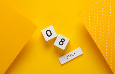 White calendar cubes with date july 08 on yellow background. Creative layout