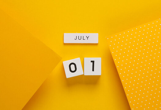 White calendar cubes with date july 01 on yellow background. creative layout