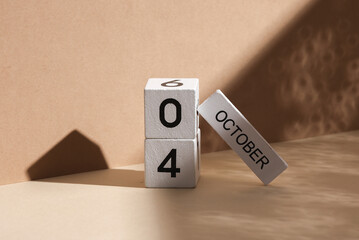 Wooden white block calendar with date october 04 on beige background with shadow. Creative layout, planning, holiday