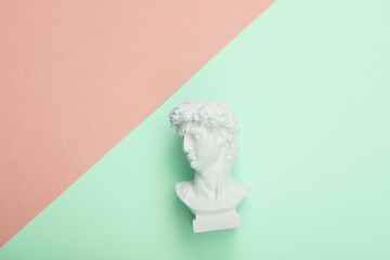 David bust on pink blue background. Cretive layout. Minimal still life. Flat lay. Top view