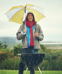 Happy man, umbrella and barbecue in rain with beer for meal, supper or dinner on the fire grill....