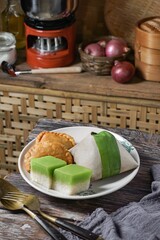 Malaysian local dishes with Nasi Lemak daun pisang (coconut rice milk), sweet slices of cake called Seri Muka, and Curry Puff