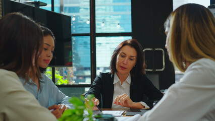 With a bright smile and a can-do attitude, Senior businesswoman explained her contract to the team in the meeting room, making sure everyone was on the same page and feeling excited.