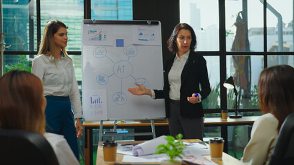 The diverse businesswoman collaborates with her team in a meeting room, discussing their AI project together while she presents her ideas.