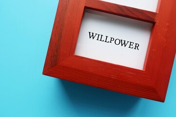 Wood photo frame with typed text WILLPOWER, means ability to control thoughts, behavior, actions,...