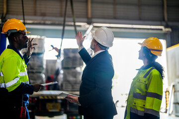 Senior boss manager inspecting with staff engineers woman and African man.Team checking...