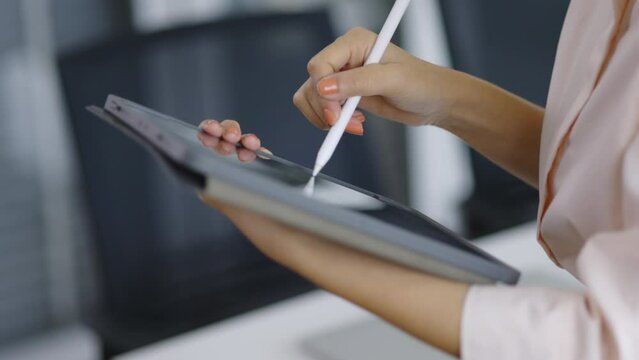 Closeup of a businessman hand writing a work note on a tablet