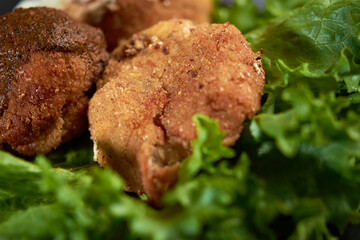 Breaded potato nuget, with orejona lettuce, with dry chile sauce, a coffee in the background