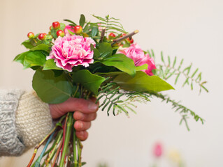 Closeup, hand and woman with a bouquet, gift and care with beauty, natural and flora. Zoom, female person and girl with flowers, nature and wellness with a present, spring and blooming with blossom