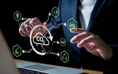 Entrepreneur hand point at digital screen dashboard while control and reduce carbon emission for global friendly business. Business with environment concern, carbon credit and zero emission.
