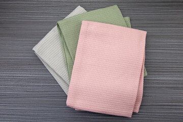 Green, pink and grey tea towels on anthracite board