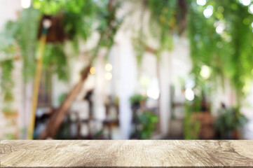 Fototapeta na wymiar Empty dark wooden table in front of abstract blurred bokeh background of restaurant . can be used for display or montage your products.Mock up for space.