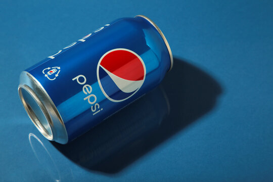 Mykolaiv, Ukraine - May 2, 2023: Pepsi drink in a can with shadow on dark blue background. Pepsi is carbonated soft drink produced by PepsiCo.