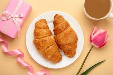 Happy mother's day, beautiful breakfast on tray, lunch with cup of coffee, fresh croissants, tulip and gift. Spring holiday, family relations.