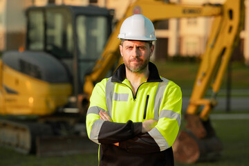 Builder at building site. Construction manager in helmet. Male construction engineer. Architect at a construction site. Handyman builder in hardhat. Building concept. Builder foreman.