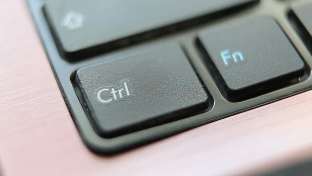Pressing the Ctrl key on a laptop keyboard.Macro shot.Looped video.