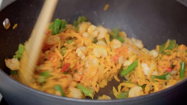 Cooking beans with shrimp and funchosa close up. Selective focus