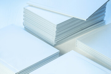 Obraz premium stacks of freshly printed photobooks on the table close-up, clean white cover