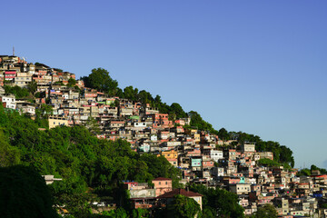 Fototapeta na wymiar A colorful favela overlooking the Atlantic ocean in Rio de Janeiro. Beautiful sunrise view to favela on hillside in Rio de Janeiro