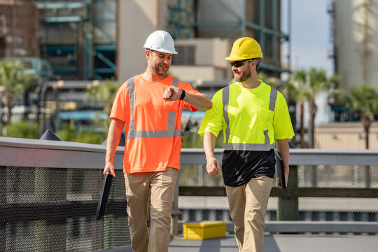 Men engineer workers, factory operators, mechanical engineering team production. Workers in helmet walk on industry zone. Industry manufacturing factory people. Industrial environment.