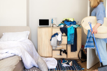 woman entered her child's room with a mess to collect dirty things and clean up