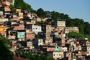 A colorful favela overlooking the Atlantic ocean in Rio de Janeiro. Beautiful sunrise view to...