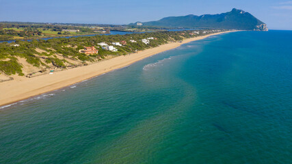 Aerial view of the seafront of Sabaudia, Italy. The beach is almost empty. In the background the Circeo promontory.