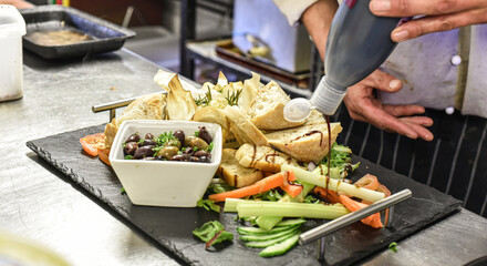 Chef working in busy kitchen preparing meals
