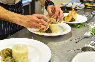 Chef working in busy kitchen preparing meals