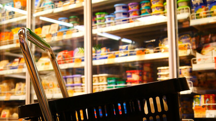 Close-up of a shopping trolley in a dairy department