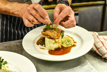 Chef working in busy kitchen preparing meals
