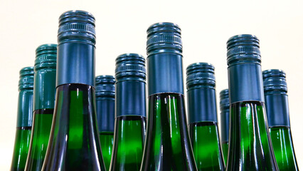 Close-up of many green glass bottles of white wine