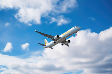 Fototapeta na wymiar Vueling Airbus A321 airplane in flight against a blue cloudy sky taking off from the airport 