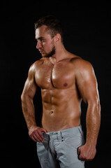 Fototapeta na wymiar Fitness and healthy lifestyle. Young attractive man with a beautiful body.