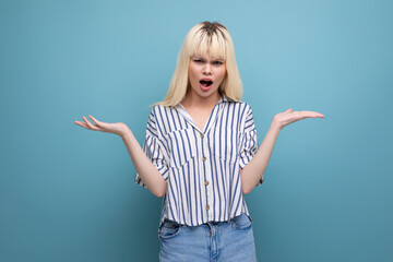 upset blonde 25 year old female person in striped blouse and jeans