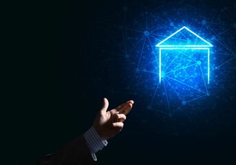 Conceptual image with hand pointing at house or main page icon on dark background