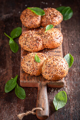 Healthy spinach buns freshly baked on wooden board.