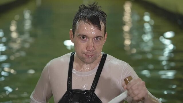 caucasian man in the pool with a paddle in his hands. close-up of a man's face. slalom kayaking. slow motion video. High quality Full HD video recording