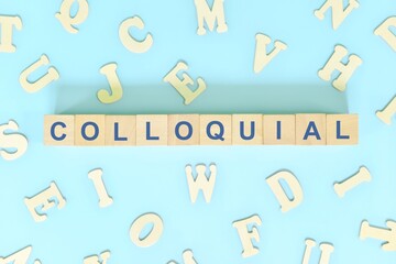 Colloquial language concept. Wooden blocks typography word flat lay in blue background.