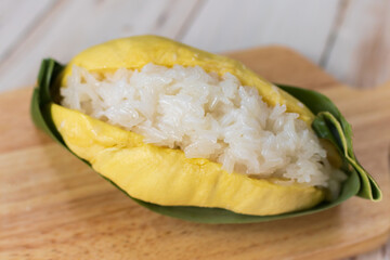 Durian with sweet sticky rice and coconut milk on top (Khao Niao Thu Lien). Thai style tropical dessert, glutinous rice eat with durian. 