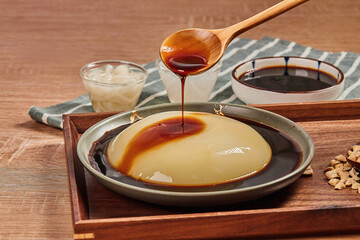 Chinese cold rice cake whit brown sugar syrup,cake made of glutinous rice served cold in summer(lianggao),Traditional Chinese Summer Snacks