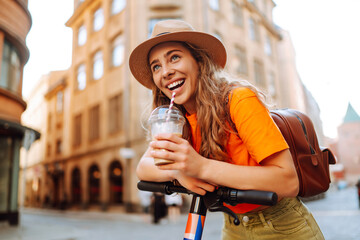 Young woman driving electric scooter through the city. Active life. Ecological transportation...