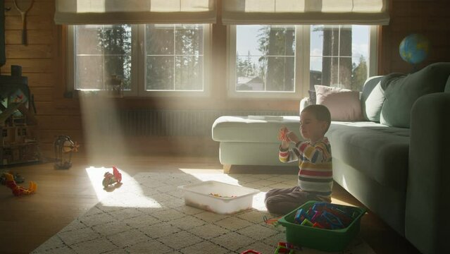 A Joyful Playtime Between a Mother and Son, they engage in playtime and spend quality time together on the floor near the sofa. beautiful atmosphere of love and happiness.