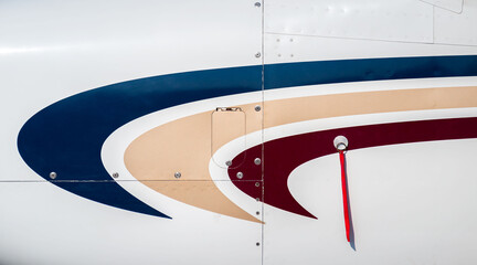 Silver metal surface of the aircraft fuselage with rivets. Fuselage detail view. Airplane metallic fuselage detail with rivets.